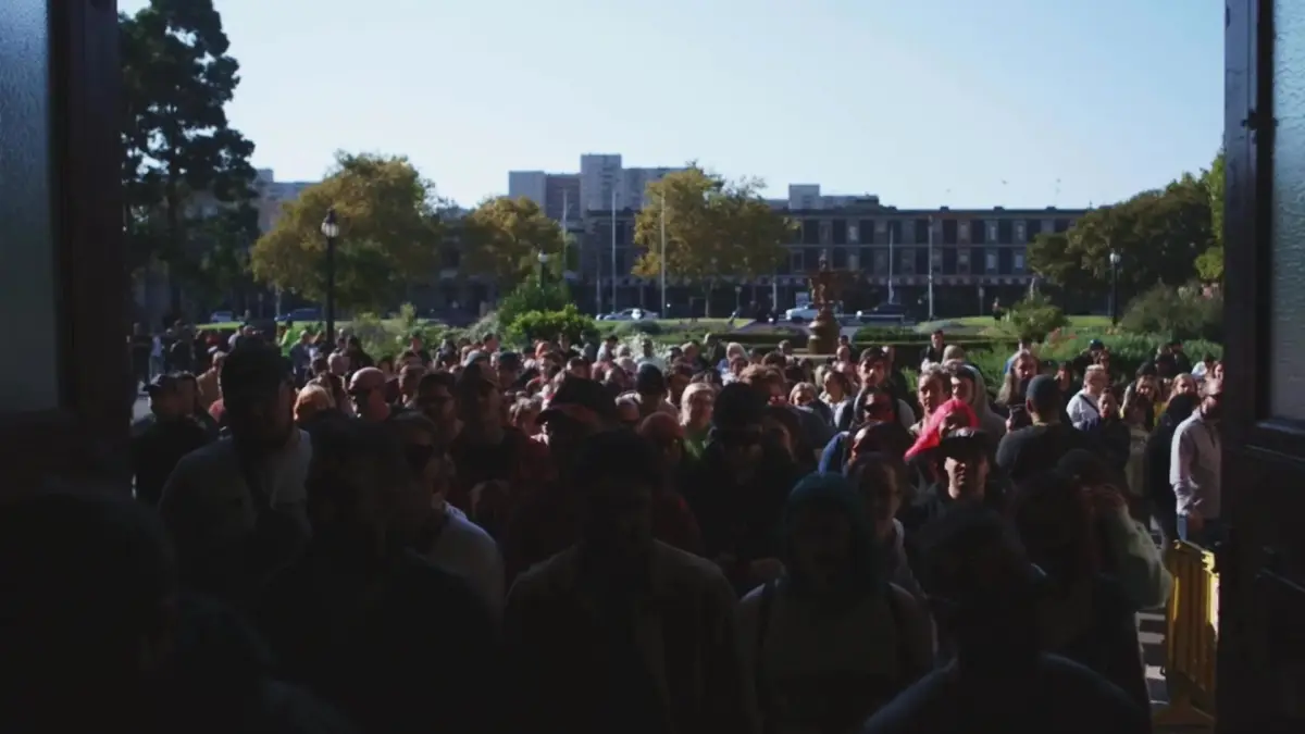A crowd waiting to enter a convention hall